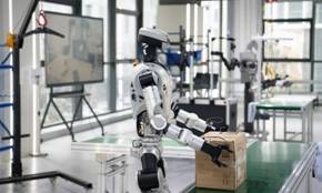 A humanoid robot conducts box-carrying training at a data collection pre-training center for humanoid robots in Hefei, east China's Anhui Province, Dec. 4, 2025. (Xinhua/Zhang Duan)
